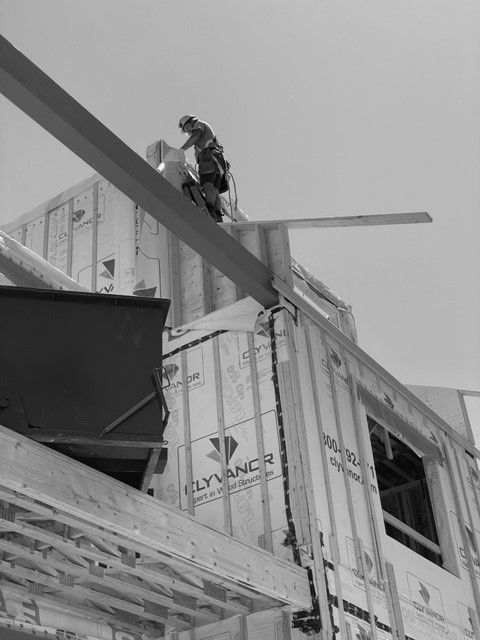 A black and white photo of a building under construction