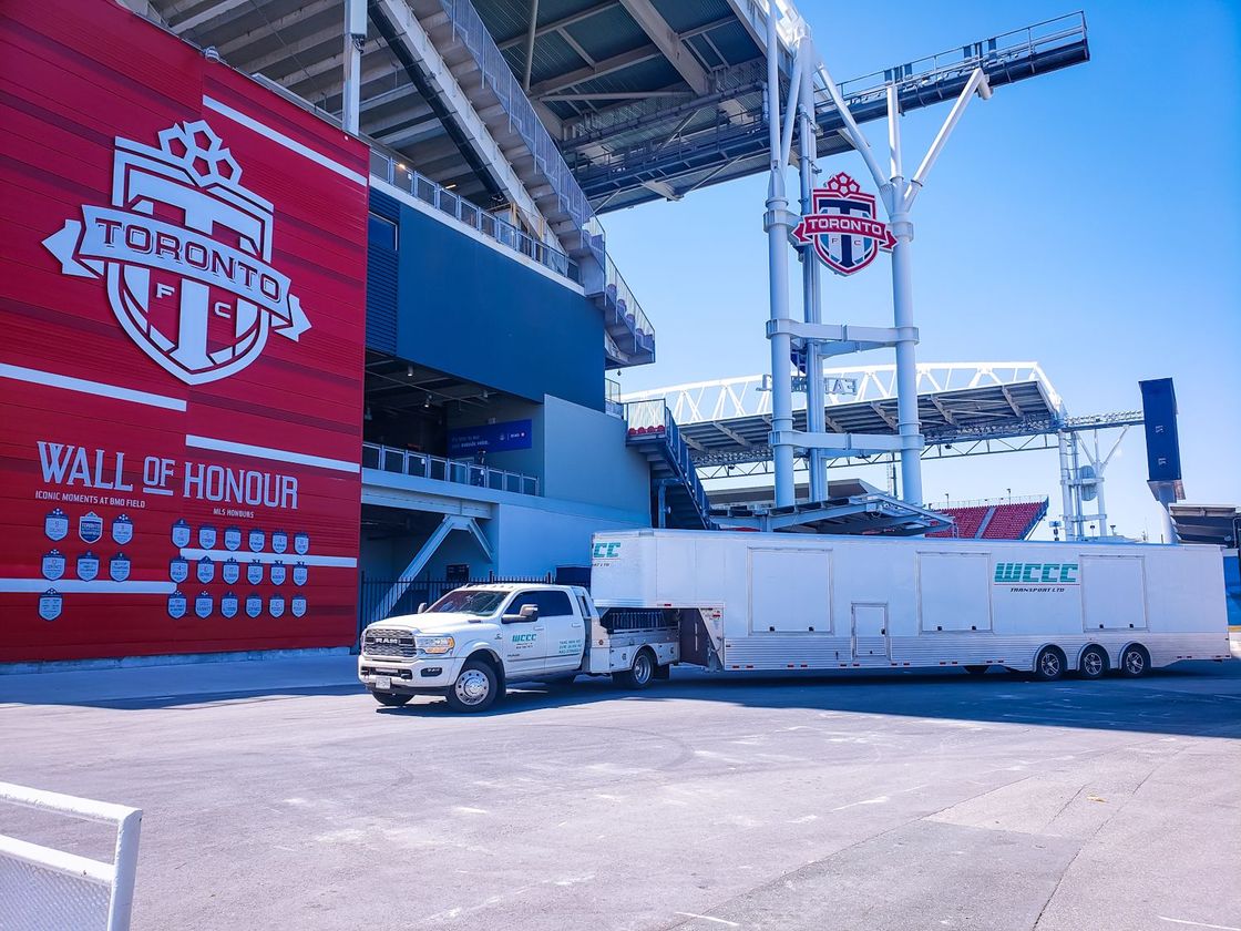 A truck is parked in front of a toronto stadium