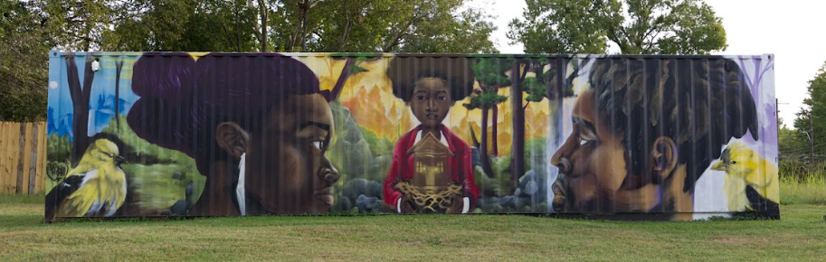 Colorful mural on a corrugated wall showing a seated figure in red, a black panther, and a large profile face.