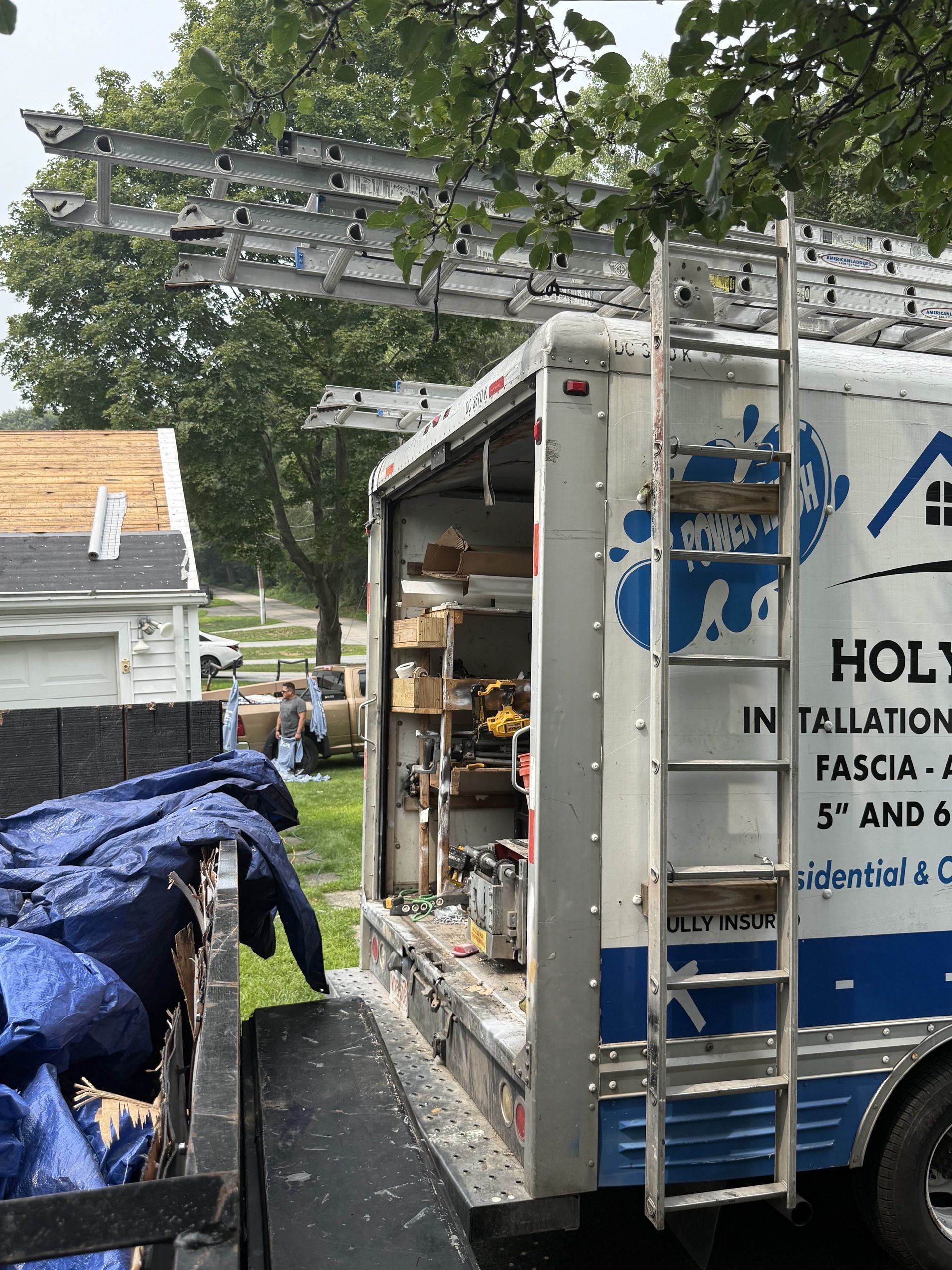 Holy Gutters technician repairing and cleaning gutters on a Worcester-area home