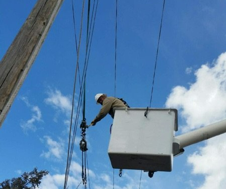 Man On A Bucket Truck For Wire Fixing — Pueblo, CO —  Main Electric