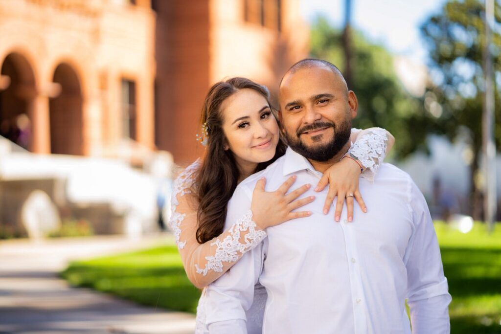 A man and a woman are posing for a picture in front of the Old Courthouse
