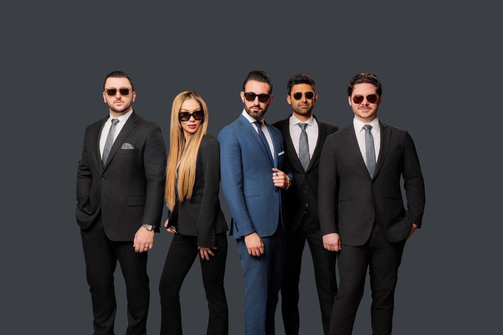 Attorney Corporate Headshots Orange County Group of people in suits and sunglasses, posing against a gray background Santa Ana Ca.