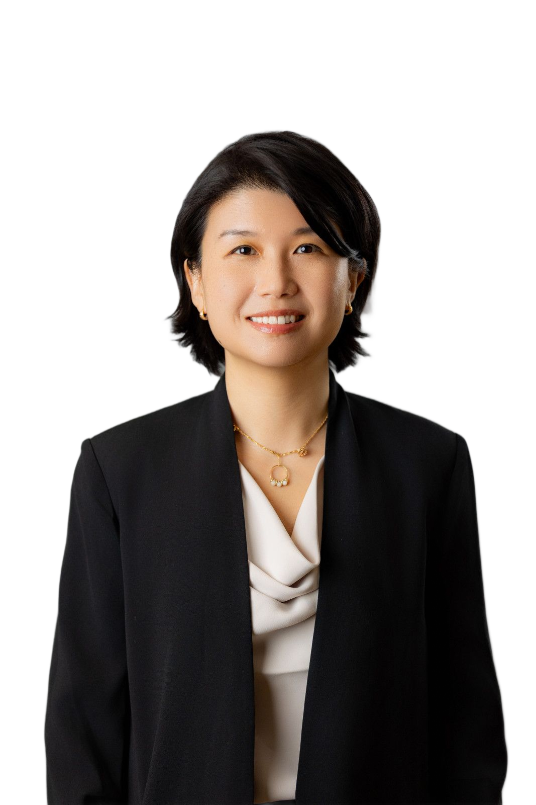 Female Corporate Headshot Woman with short black hair, smiling, wearing a black blazer and necklace, against a white background.