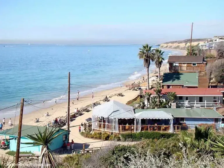 A view of a beach at crystal cove with a white tent in the foreground