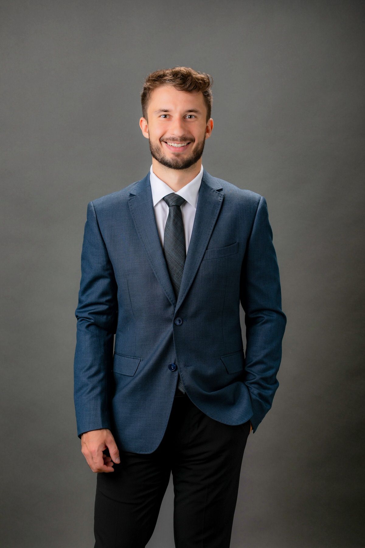 professional studio headshot example — classic business portrait with neutral studio backdrop