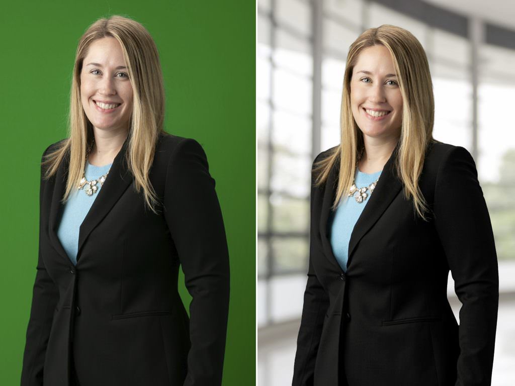 A woman in a suit is standing in front of a green background.