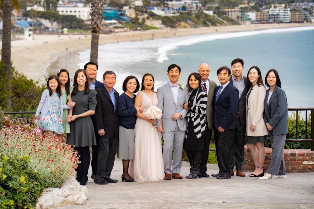 A group of people are posing for a picture in front of main beach in Laguna.
