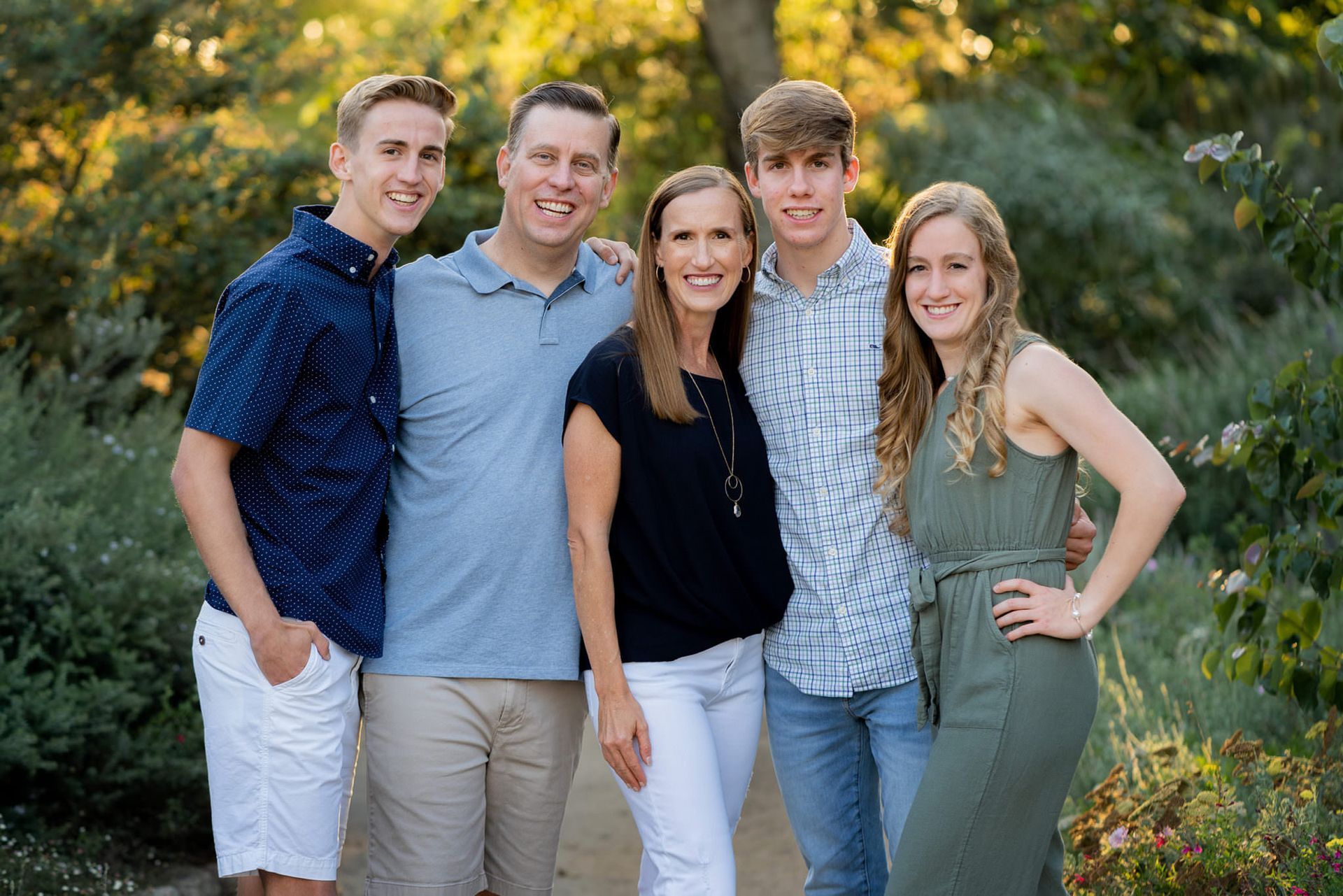A family posing for a picture together in a park.