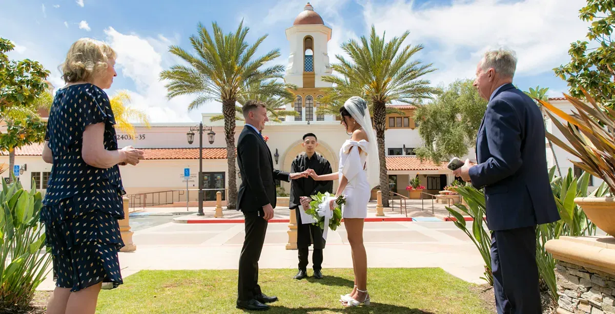 A bride and groom are getting married in front of a church.