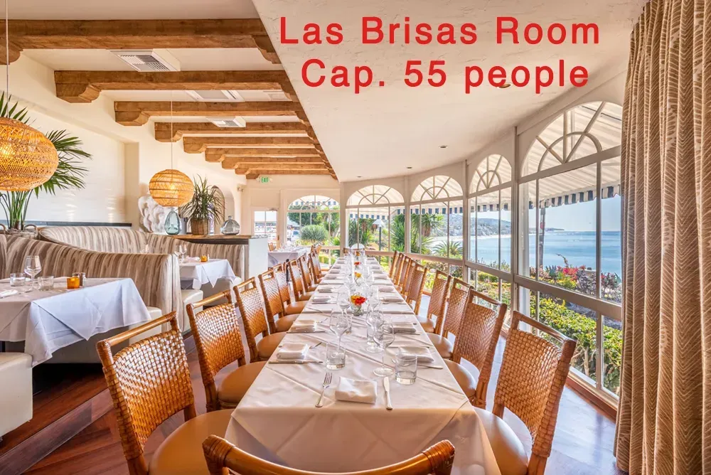 A long table in a restaurant with the words las brisas room cap 55 people