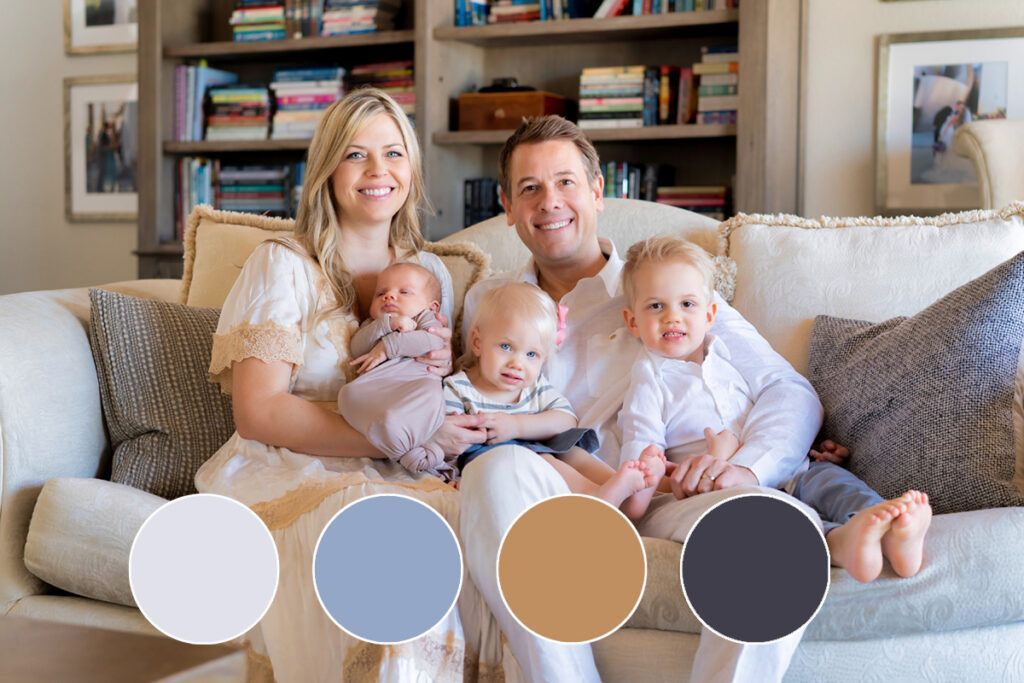 A family is sitting on a couch in a living room.