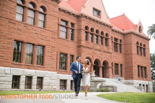 A man and woman are walking in front  the old courthouse in Santa Ana.