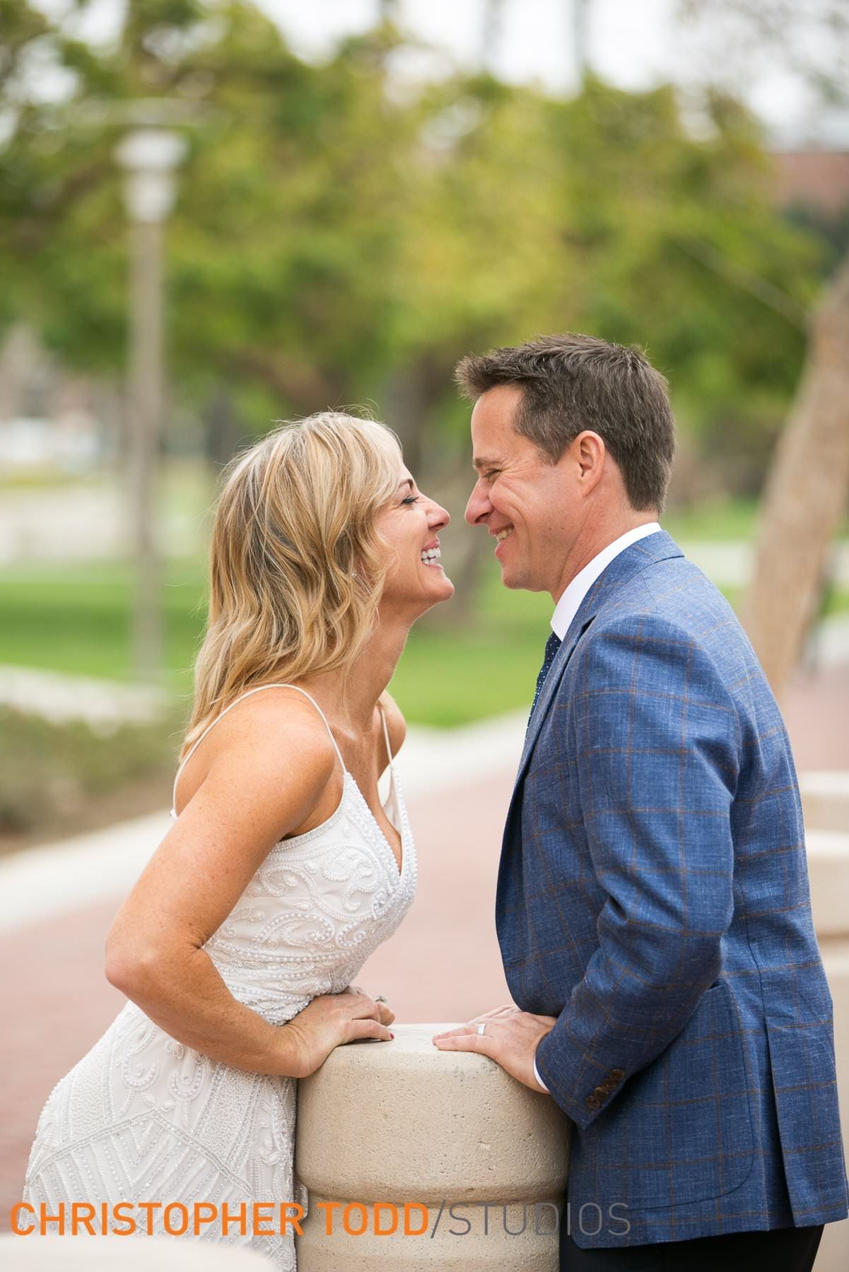 A bride and groom are looking at each other at the Ronald Reagan Federal Building in Santa Ana