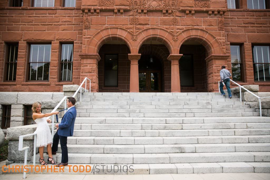A man and woman are standing on the steps at the Old Courthouse in Orange County