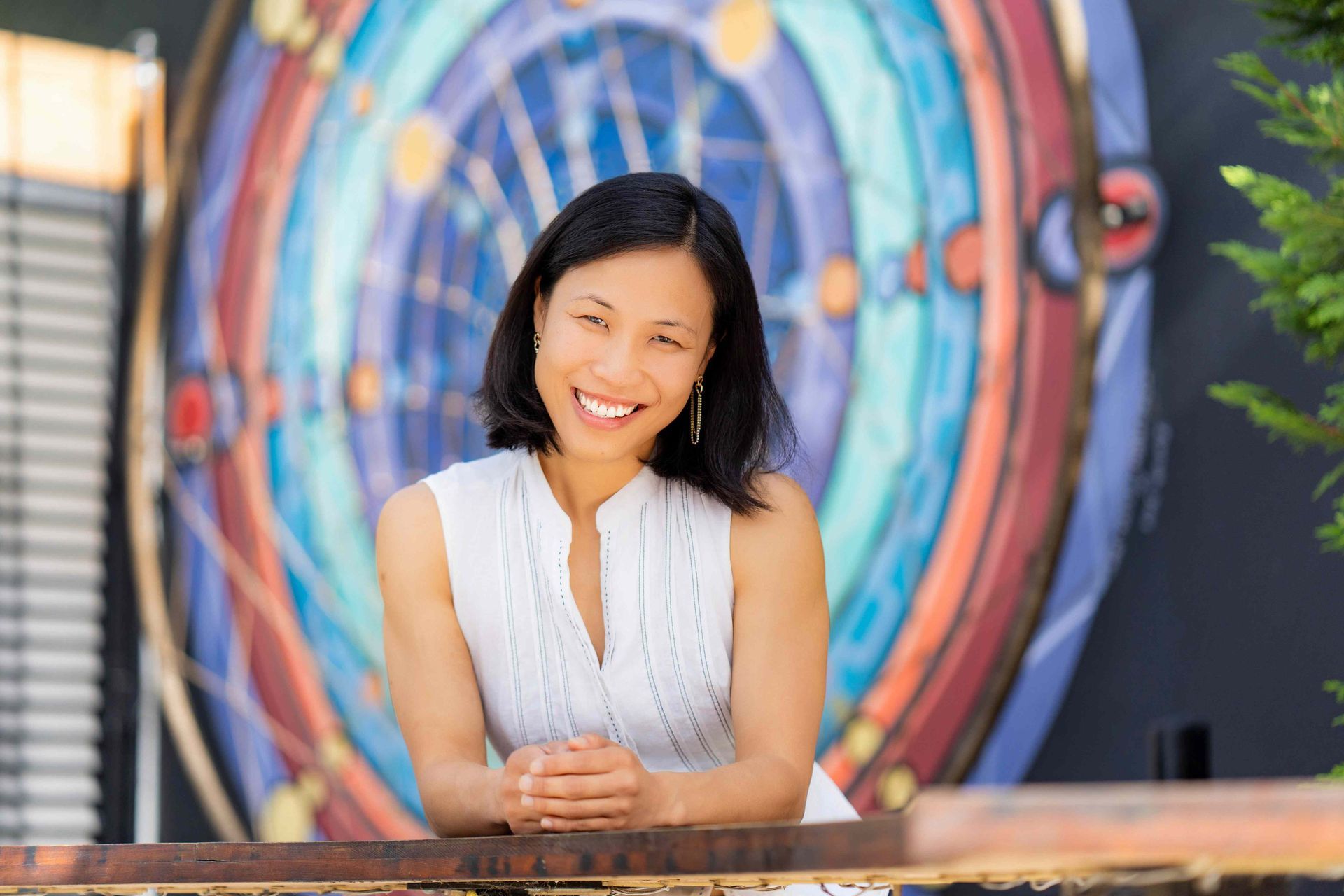 Costa Mesa Photographer A woman is standing in front of a mural on a wall