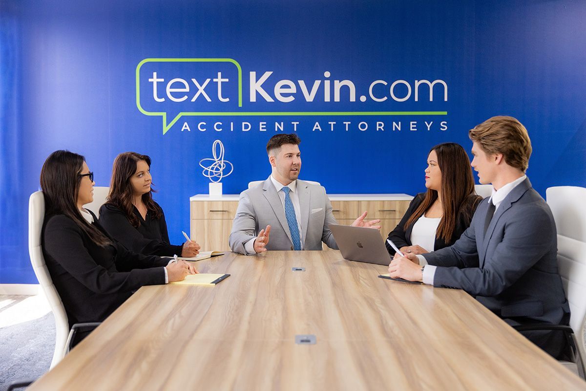 A group of lawyers are sitting around a conference table.
