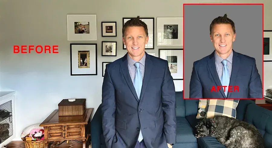 A man in a suit and tie is standing in a living room.