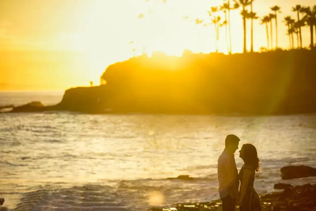 A man and a woman are standing on the beach at Shaws Cove Laguna Beach