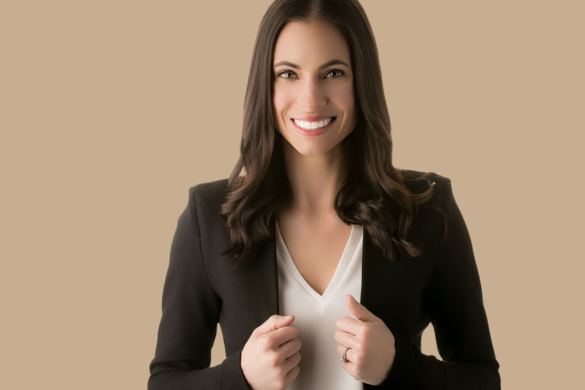 Actor Headshot Costa Mesa Photograpehr A woman wearing a black jacket and a white shirt is smiling.