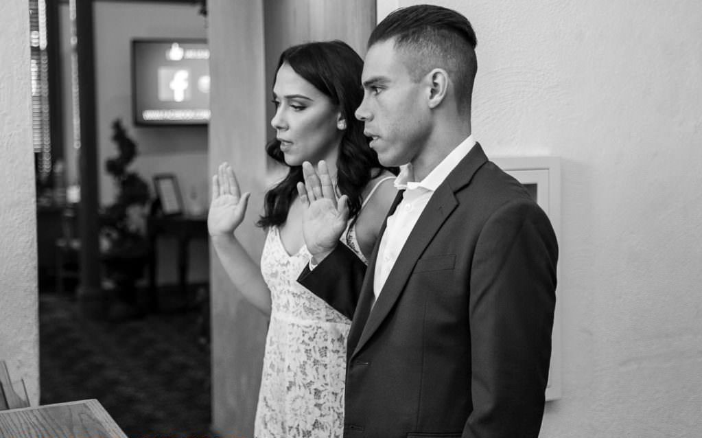 Santa Ana Courthouse elopement A bride and groom taking their oath before their civil ceremony at the old orange county courthouse in Santa Ana.