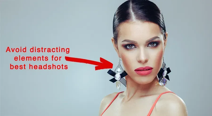 A woman with distracting earings a red arrow pointing to her ear says avoid distracting elements for best headshots