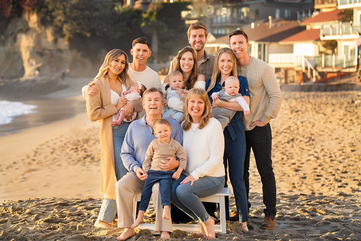 Portraits For Big Families In OC A large family is posing for a picture on the beach.