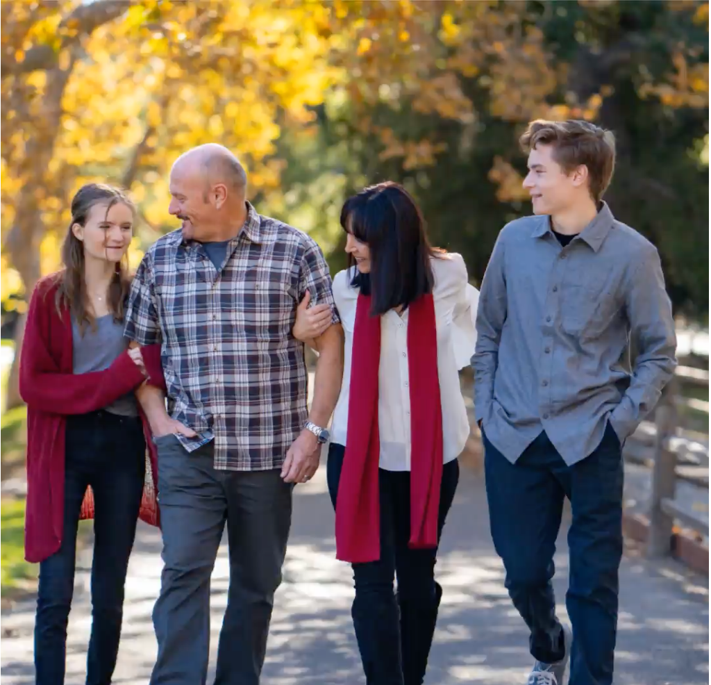 A family walking down a path together in Irvine Regional Park.