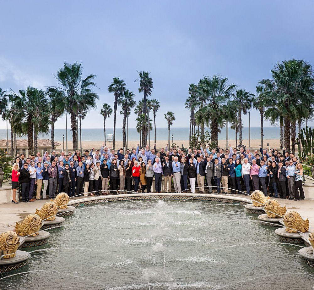 A large group of people standing in front of a fountain