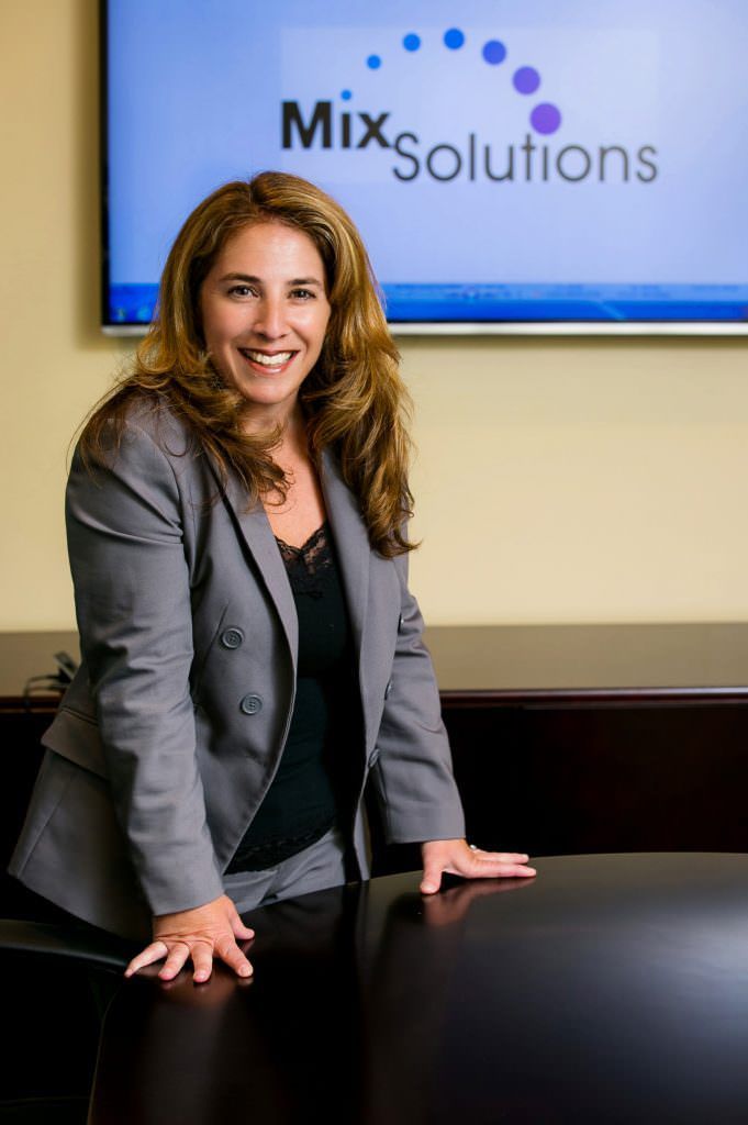 A business woman is leaning on a table