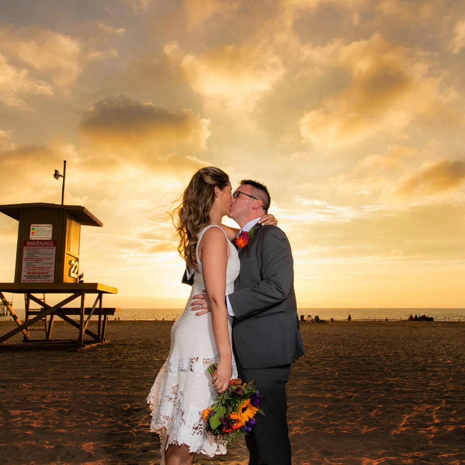Bride and Groom Sunset Newport Beach A bride and groom kissing on the beach at sunset in Newport Beach.