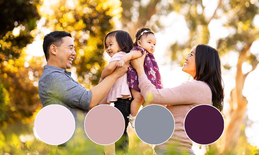 A family is posing for a picture in a park.