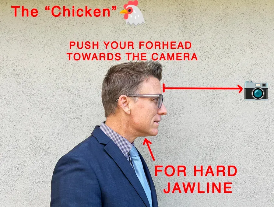 A man in a suit and tie is pushing his forehead towards a camera for a better headshot