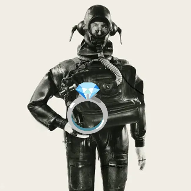 A man in a vintage scuba suit is holding a diamond ring