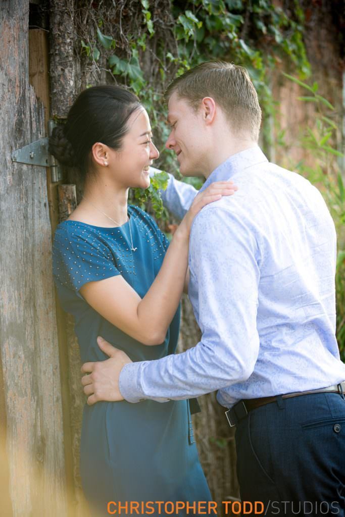 An engaged man and a woman are hugging each other at the Lab in Costa Mesa