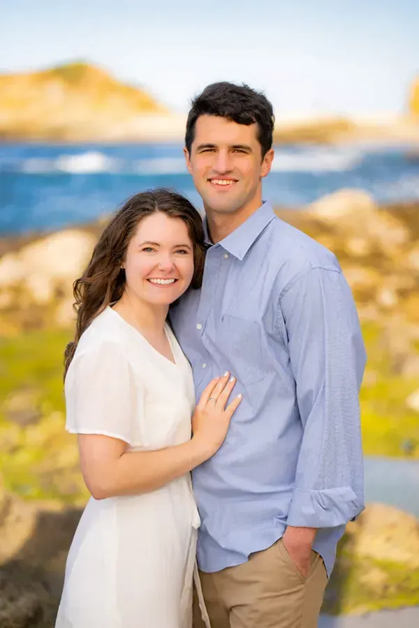 A man and a woman are posing for a picture in Laguna Beach