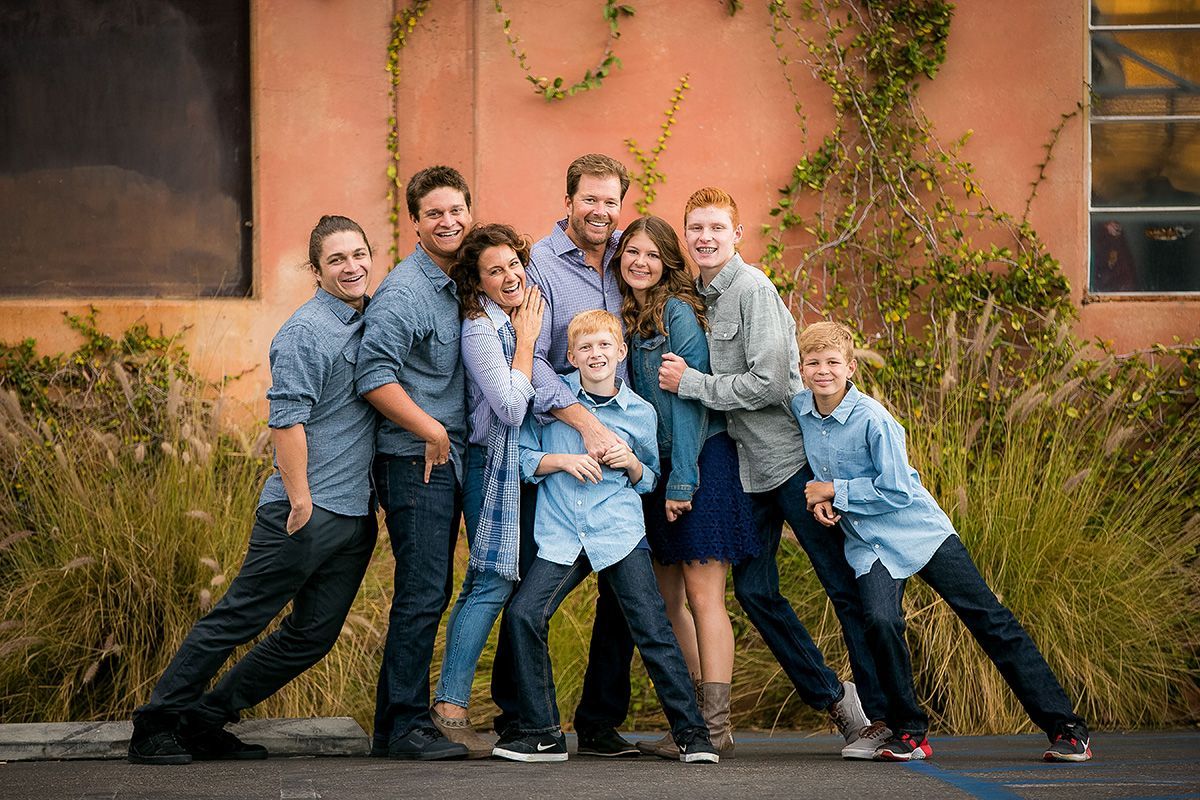 Eclectic Locations Family Portraits In OC A large family is posing for a picture in front of a building