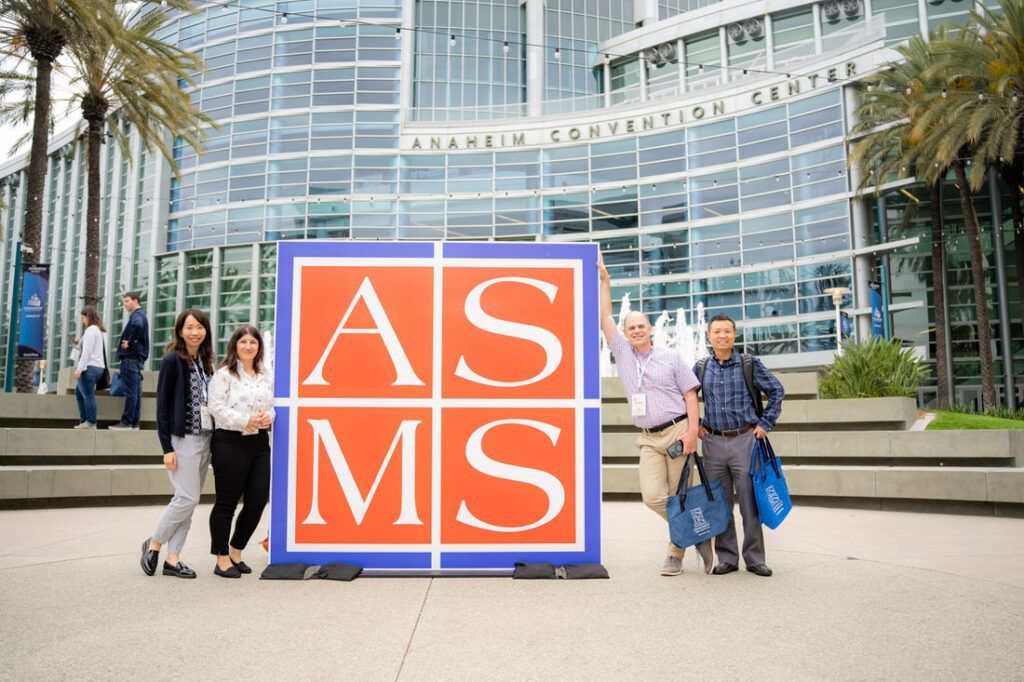 A group of people standing in front of Anaheim Convention Center.