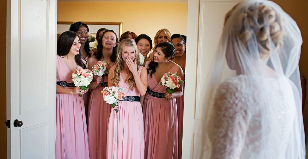A bride and her bridesmaids are standing in a doorway at the Pendry Hotel in Newport Beach