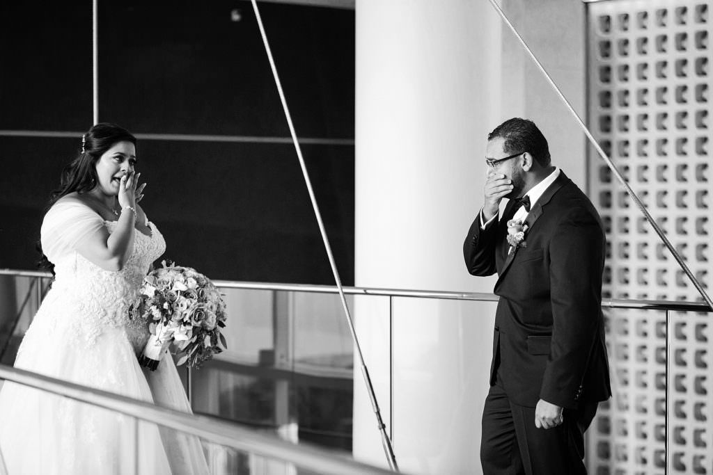 A bride and groom both crying during their first look in Beverly Hills
