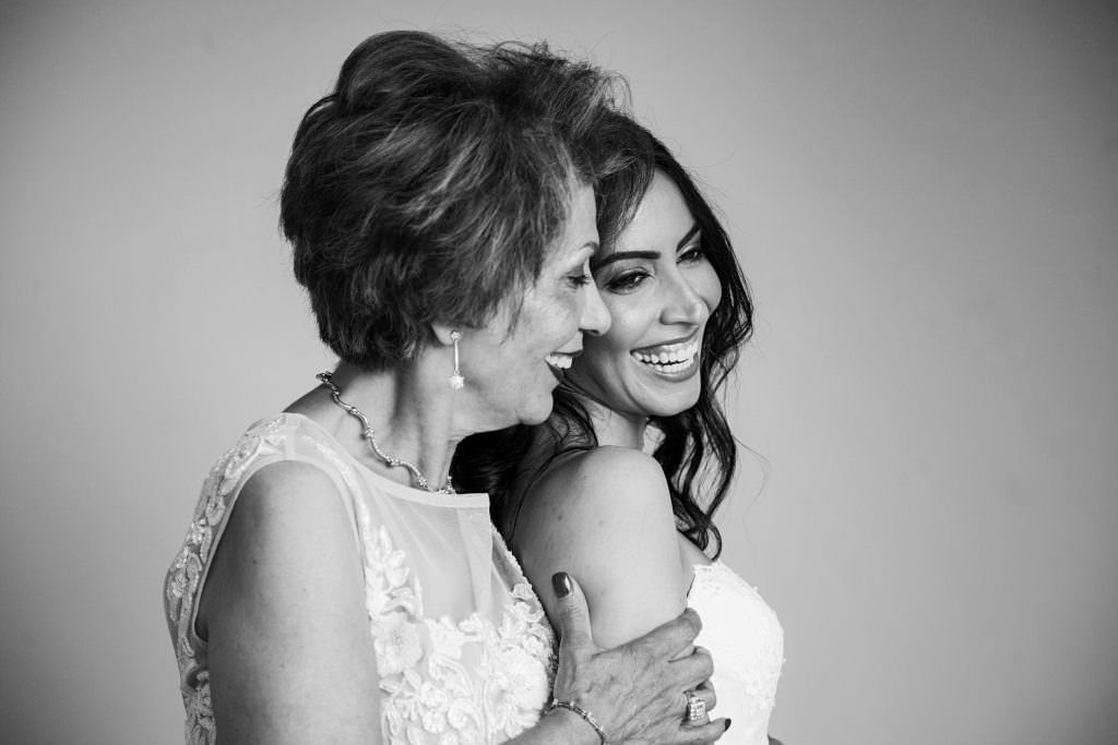 A mother and daughter are hugging each other before her wedding