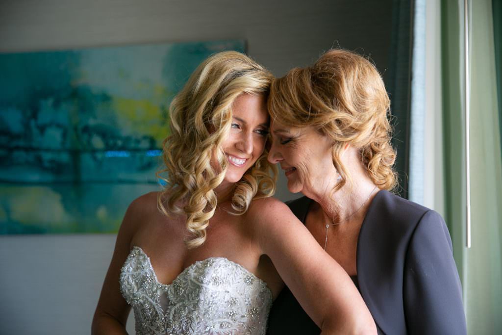 A bride and her mother are standing next to each other in the shorebreak hotel in Huntington beach