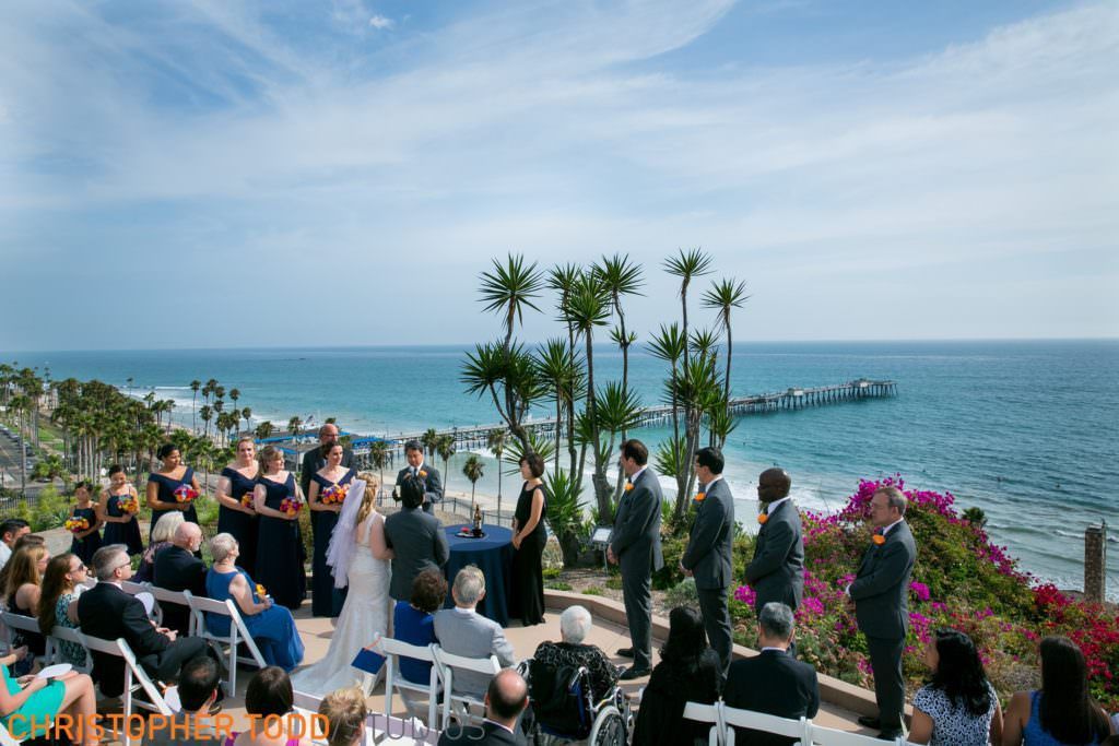 A wedding ceremony is taking place at Casa Romantica in San Clemente