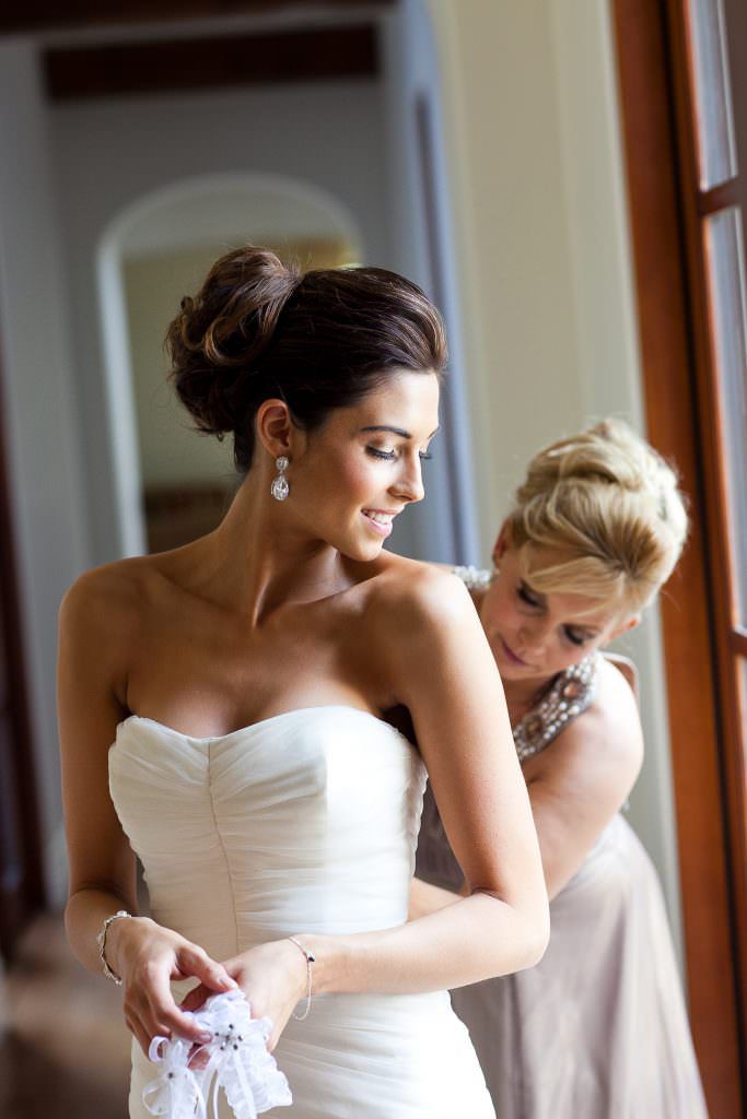 A mother is helping her daughter get ready for her wedding in Shady Canyon Irvine, CA.