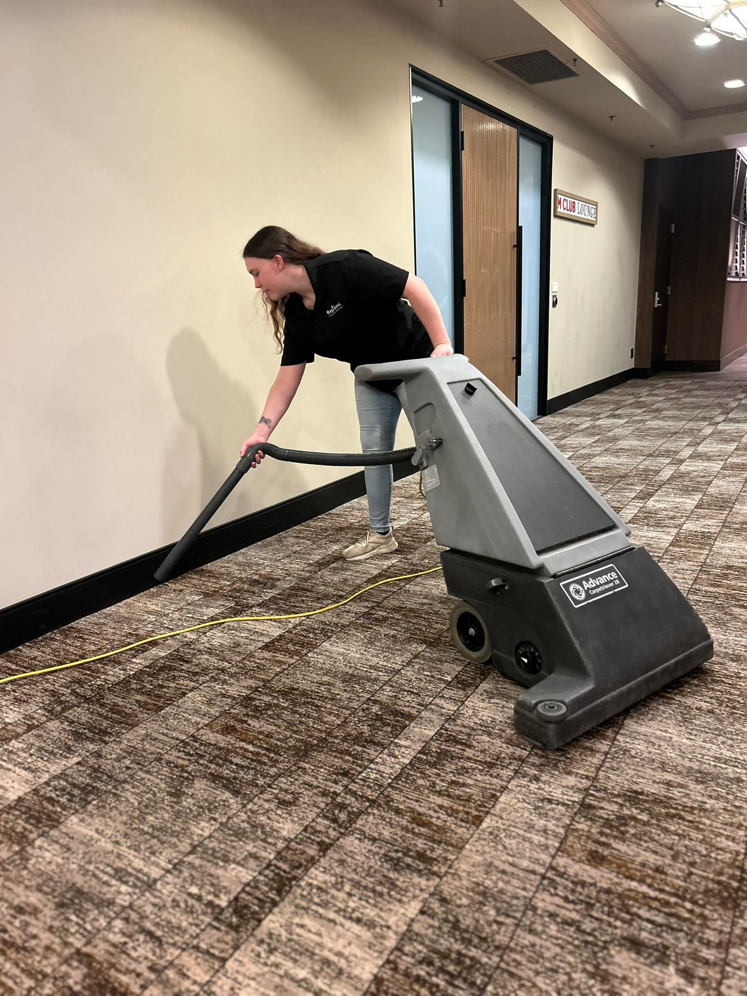 Person cleaning floor with a vacuum cleaner Person cleaning floor with a vacuum cleaner