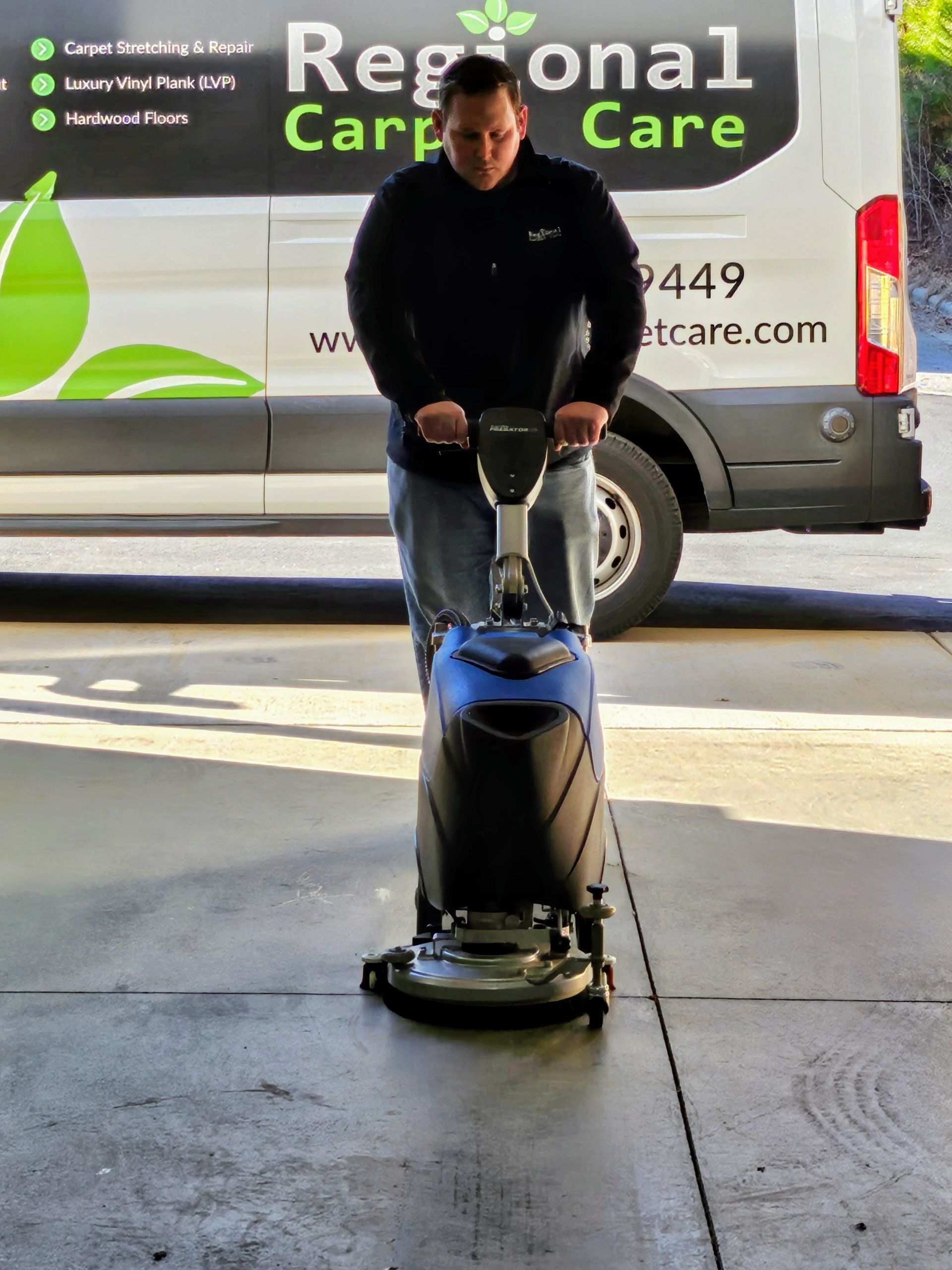 A person holding commercial floor scrubber drier machine A person holding commercial floor scrubber drier machine