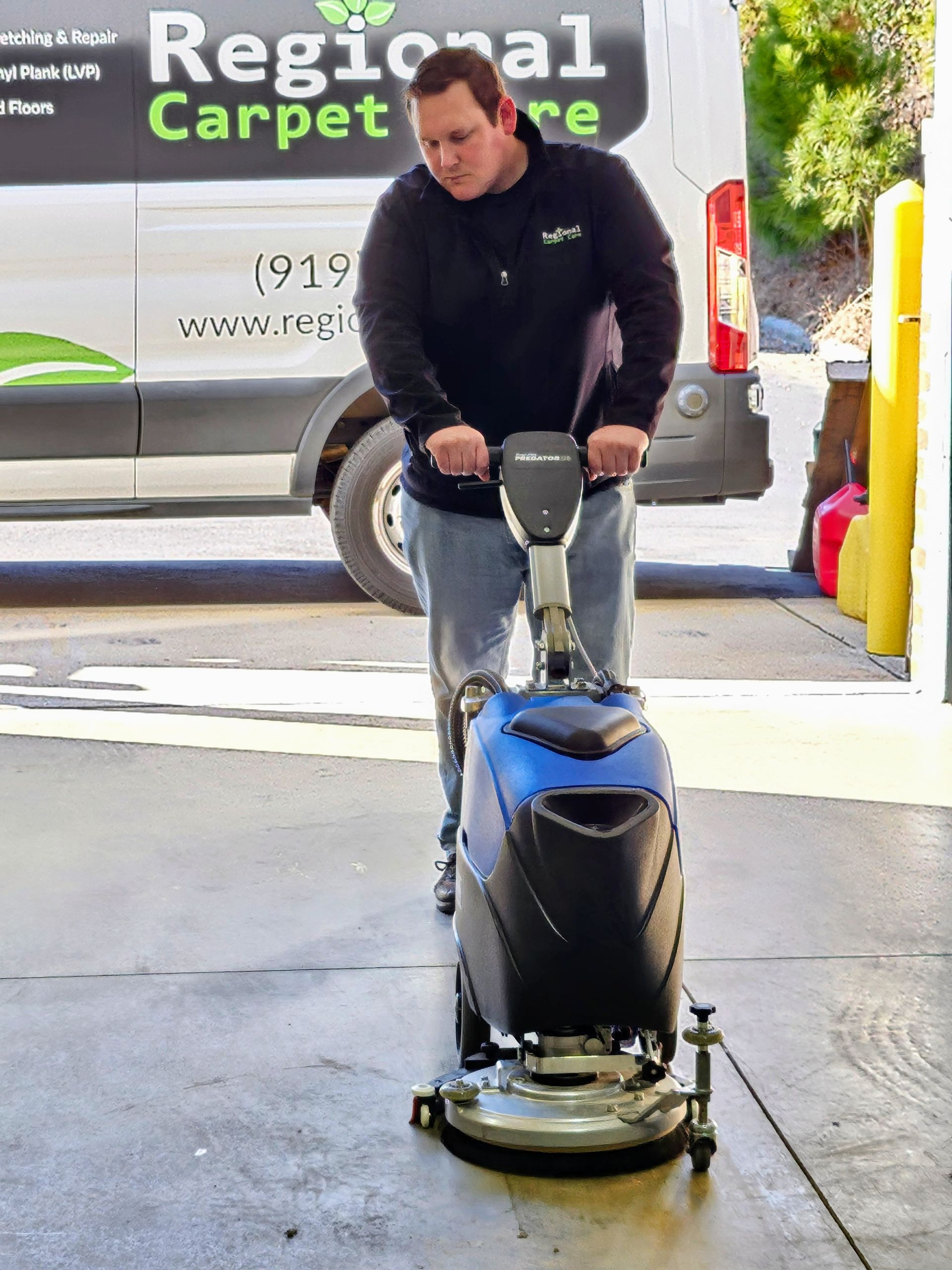 A person holding commercial floor scrubber drier machine