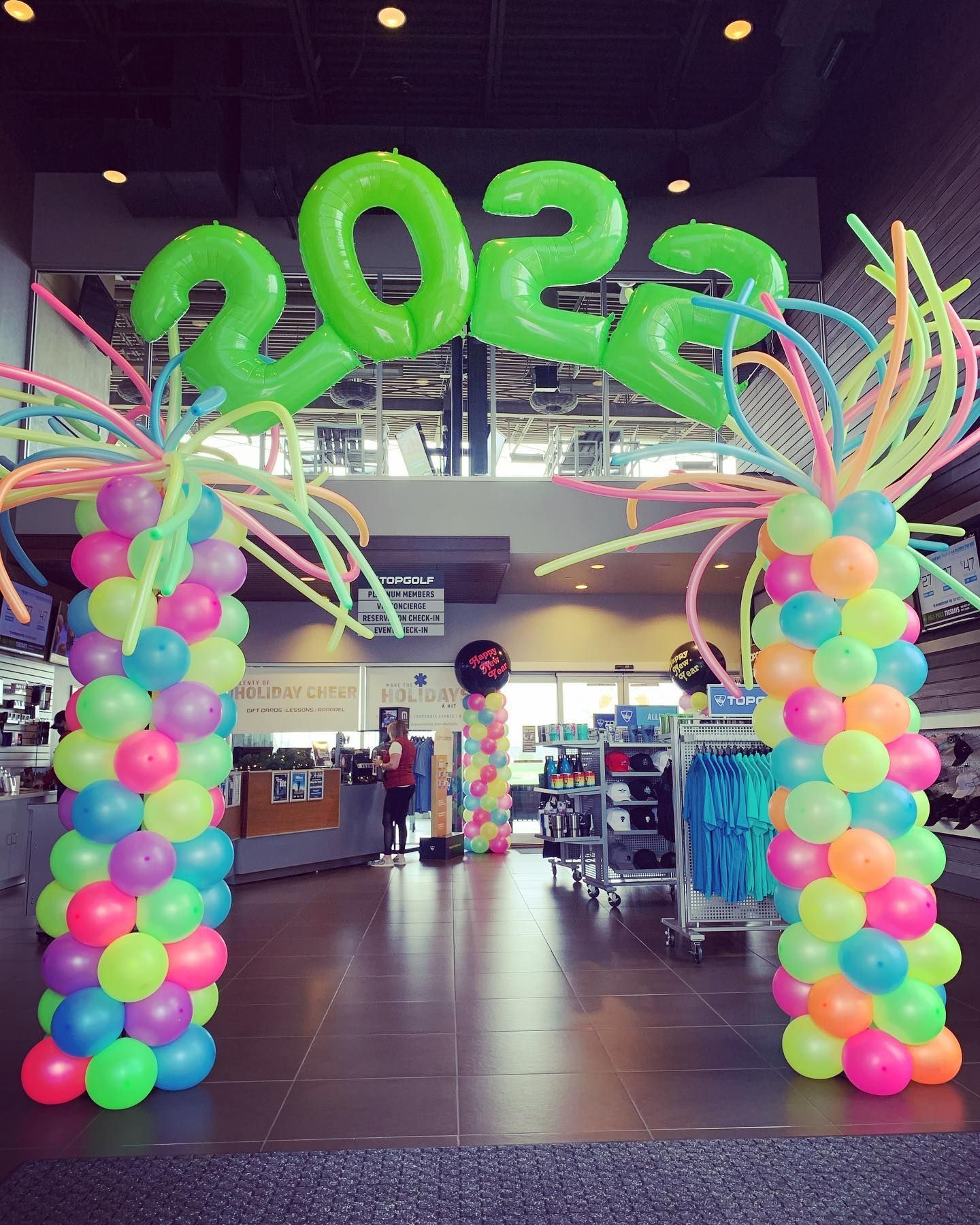 A bunch of colorful balloons with the year 2022 on them