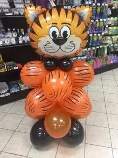 A tiger made out of balloons in a store.