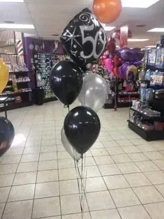 A bunch of balloons with one that says 50 on it